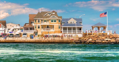 view of a boardwalk and homes along the water in point pleasant beach, new jersey