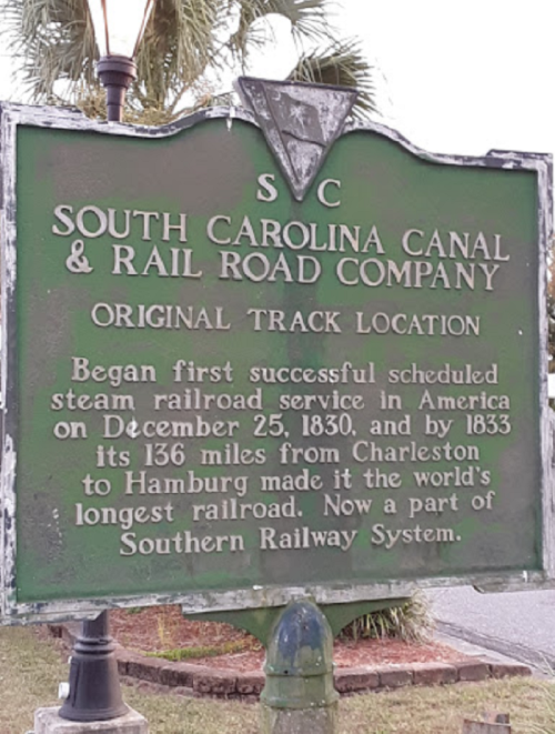 Historical sign for the South Carolina Canal & Railroad Company, detailing its original track location and significance.