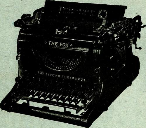 An antique typewriter labeled "THE FOX" with a classic design and visible keys.