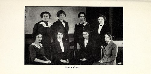 A black-and-white photo of nine women in formal attire, posed together for a senior class portrait.
