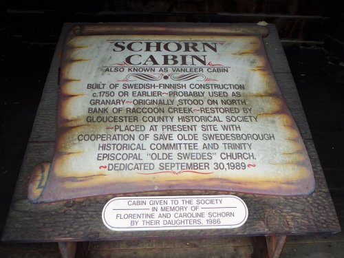 Sign for Schorn Cabin, detailing its history and restoration, dedicated in 1989 in memory of Florentine and Caroline Schorn.