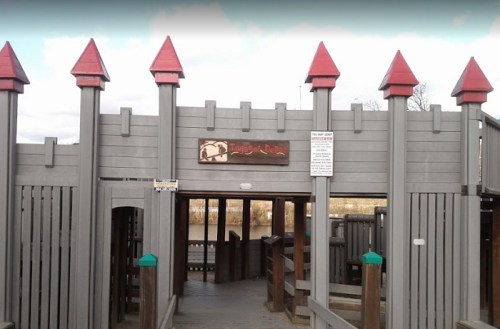 Playground entrance featuring a wooden structure with castle-like towers and a sign reading "Knight's Domain."
