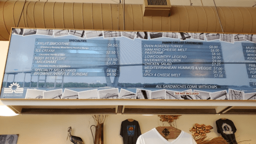 Menu board displaying specials and prices for smoothies, ice cream, sandwiches, and desserts.