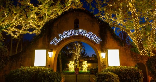 an entrance to tlaquepaque village in sedona adorned in christmas lights at night