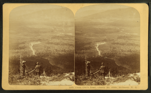 A vintage photo showing two men overlooking a valley from a mountain peak in Jefferson, New Hampshire.
