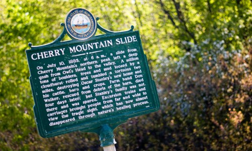 Historical marker about the Cherry Mountain Slide, detailing the event from October 10, 1885, and its aftermath.