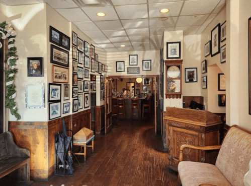 Cozy restaurant interior with wooden accents, framed photos on the walls, and a welcoming seating area.