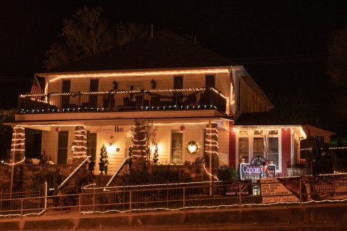 A beautifully decorated house at night, adorned with festive lights and holiday decorations.