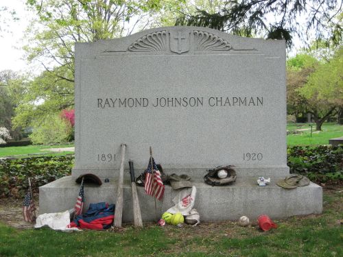 Gravestone of Raymond Johnson Chapman (1891-1920) adorned with baseball equipment and American flags.