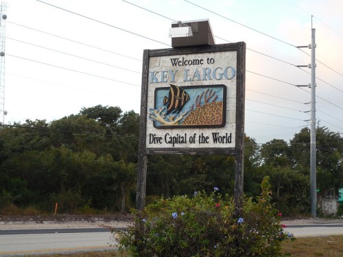 Welcome sign for Key Largo, featuring "Dive Capital of the World" with a colorful fish design.