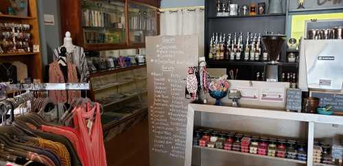 A cozy shop interior featuring shelves of books, a drink counter, and a menu board with various flavors listed.