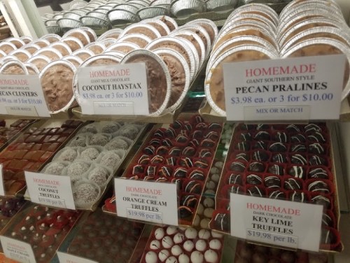 A display of various homemade chocolates and truffles, including coconut haystax, pecan pralines, and key lime truffles.