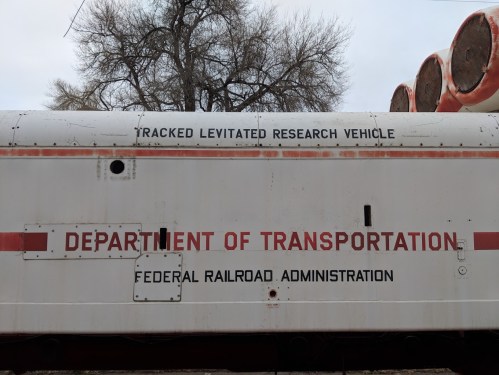 Side of a train car displaying "Tracked Levitated Research Vehicle" and "Department of Transportation" signage.