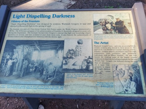 Sign about the "Light Dispelling Darkness" fountain, featuring historical images and details about the artist, Waylande Gregory.