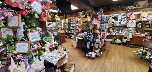 A cozy shop filled with colorful crafts, decorations, and gifts, showcasing a variety of items on wooden shelves.