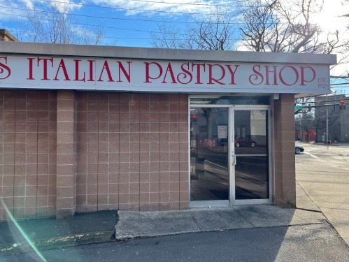 Exterior of an Italian pastry shop with a sign that reads "Italian Pastry Shop" and establishment year 1929.