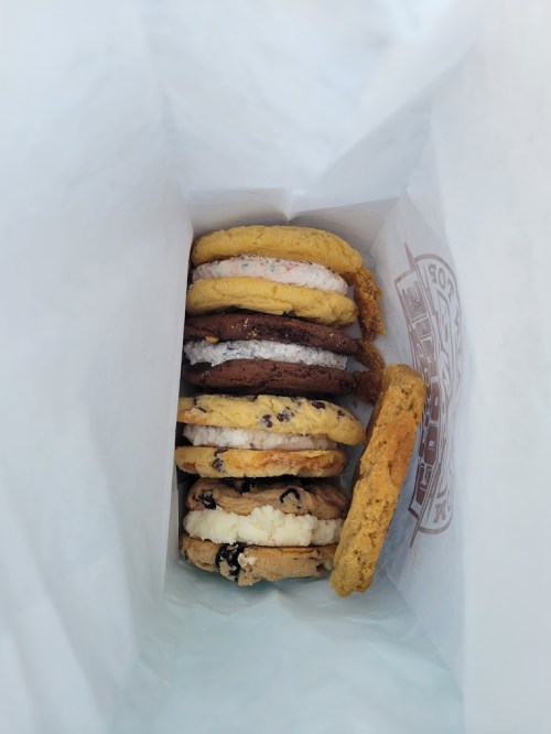 A bag filled with various colorful cookies stacked neatly inside.