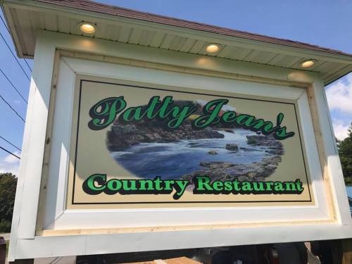 Sign for Patty Jean's Country Restaurant featuring a scenic river view and green lettering.