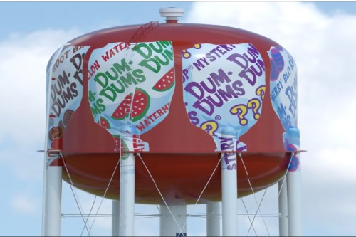 A colorful water tower featuring Dum Dums candy designs, including flavors like watermelon and mystery.