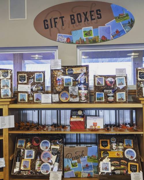 Display of gift boxes featuring various snacks and treats, with a sign above reading "Gift Boxes."