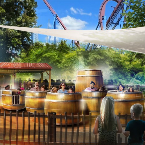 A lively amusement park scene featuring guests enjoying a barrel ride surrounded by greenery and a roller coaster in the background.