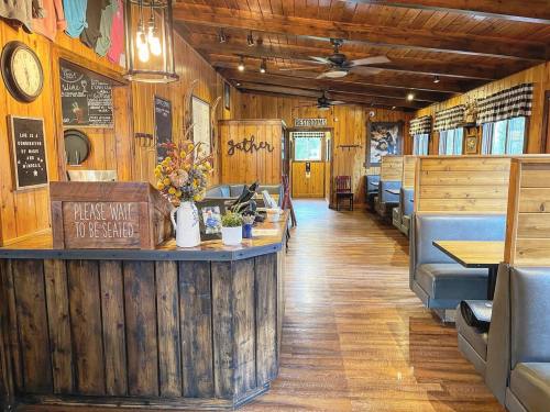 Cozy restaurant interior with wooden decor, seating booths, and a welcoming reception area.