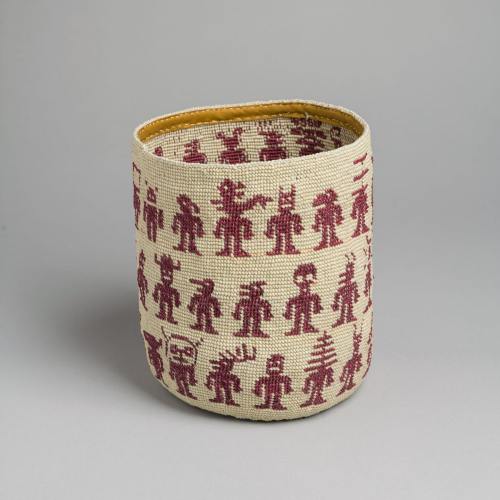 A woven basket featuring a repeating pattern of stylized figures in red on a natural background.