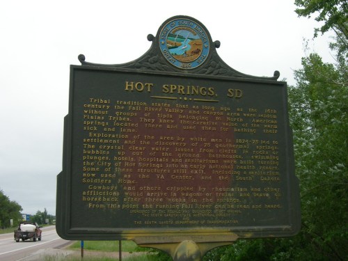 A historical marker in Hot Springs, SD, detailing tribal traditions and the area's exploration and development.