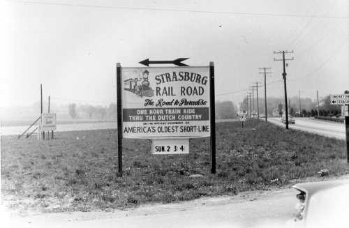 Sign for Strasburg Rail Road, promoting train rides through the Dutch Country, with a vintage aesthetic.