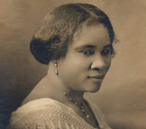 A vintage portrait of a woman with a stylish bob hairstyle, wearing a necklace and a soft expression.