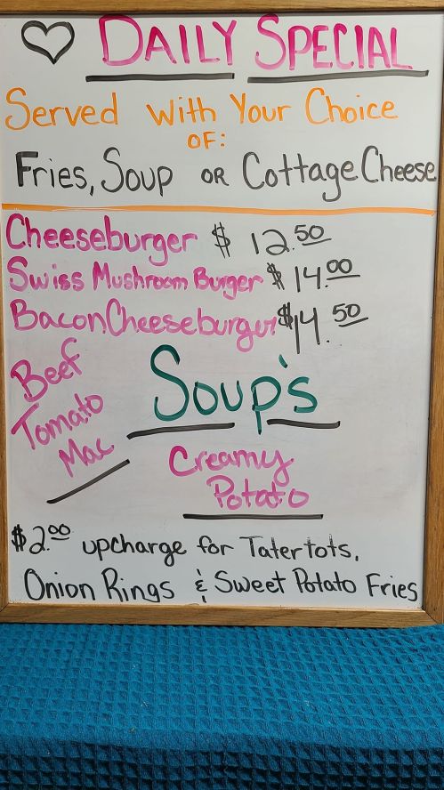 Daily special menu board featuring burgers, soups, and sides with prices listed.
