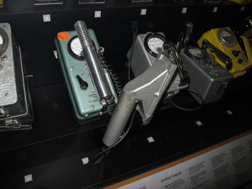 A display of vintage geiger counters in various colors, showcasing their unique designs and features.