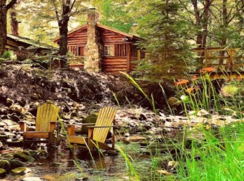A rustic cabin by a stream, with two wooden chairs on the water's edge surrounded by lush greenery.