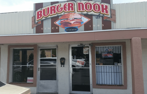 Sign for Burger Nook, a casual eatery, featuring a burger graphic and "Since 1983" text above the entrance.