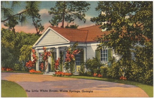 Postcard of The Little White House in Warm Springs, Georgia, featuring a charming exterior with lush greenery and flowers.