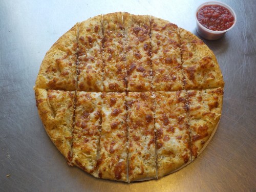 A round, cheesy pizza cut into 16 slices, served with a small cup of marinara sauce on the side.