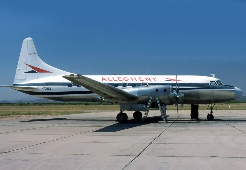 A vintage Allegheny Airlines aircraft parked on a runway under a clear blue sky.