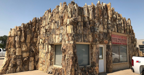 A unique building with a textured, rock-like exterior resembling a natural formation.