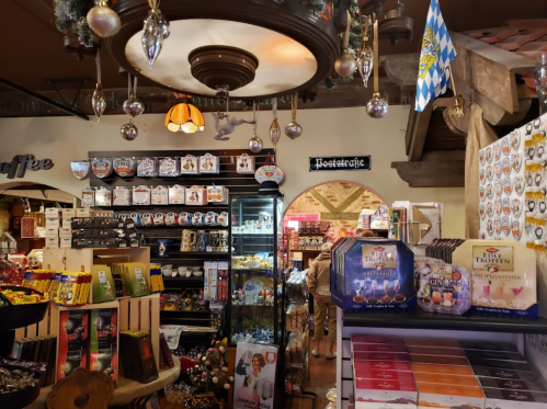 A cozy shop interior filled with festive decorations, sweets, and various merchandise, featuring a warm, inviting atmosphere.