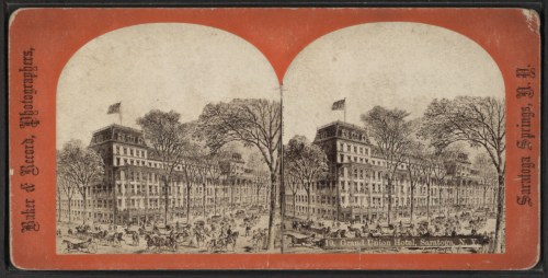 Historic stereoscopic image of the Grand Union Hotel in Saratoga Springs, featuring trees and horse-drawn carriages.
