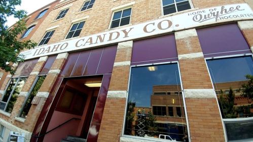Exterior of the Idaho Candy Co. building, featuring a vintage sign and brick facade.
