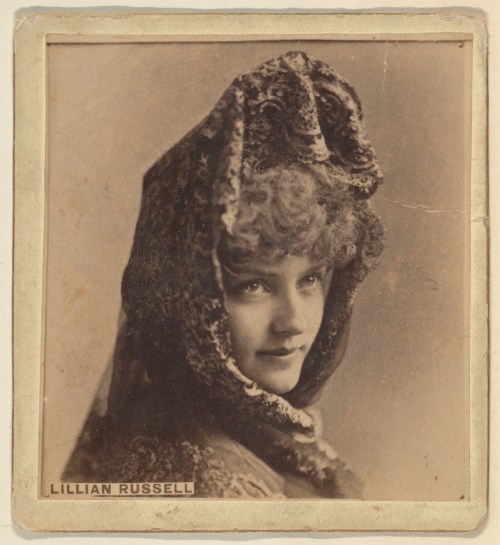 A vintage portrait of a woman with curly hair, wearing a decorative hood and looking thoughtfully to the side.