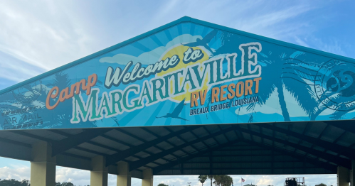 Sign welcoming visitors to Camp Margaritaville RV Resort in Breaux Bridge, Louisiana, with a colorful tropical design.