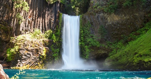 Oregon's Toketee Falls tumbles into bright blue water.