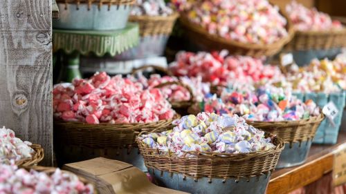 Baskets filled with colorful, assorted candies in a rustic setting.