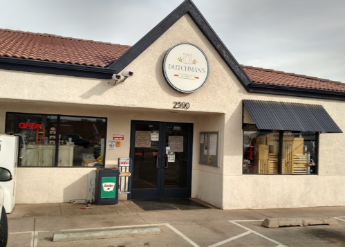 Exterior of Dutchman's restaurant with a sign, open door, and large windows, located at 2300.