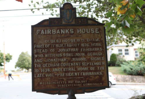 Historical marker for Fairbanks House, Dedham, MA, noting its significance and construction date of 1636.