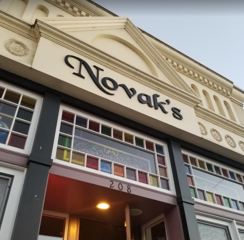 Sign for "Novak's" above a colorful entrance with decorative windows.