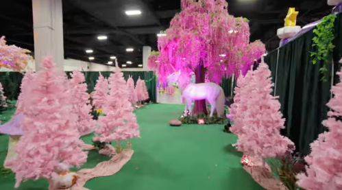 A whimsical pathway lined with pink trees, leading to a glowing unicorn under a pink tree in a vibrant setting.