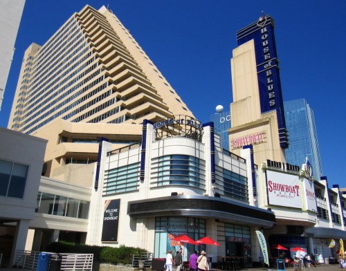 A large building featuring the House of Blues sign, with a clear blue sky and people walking outside.